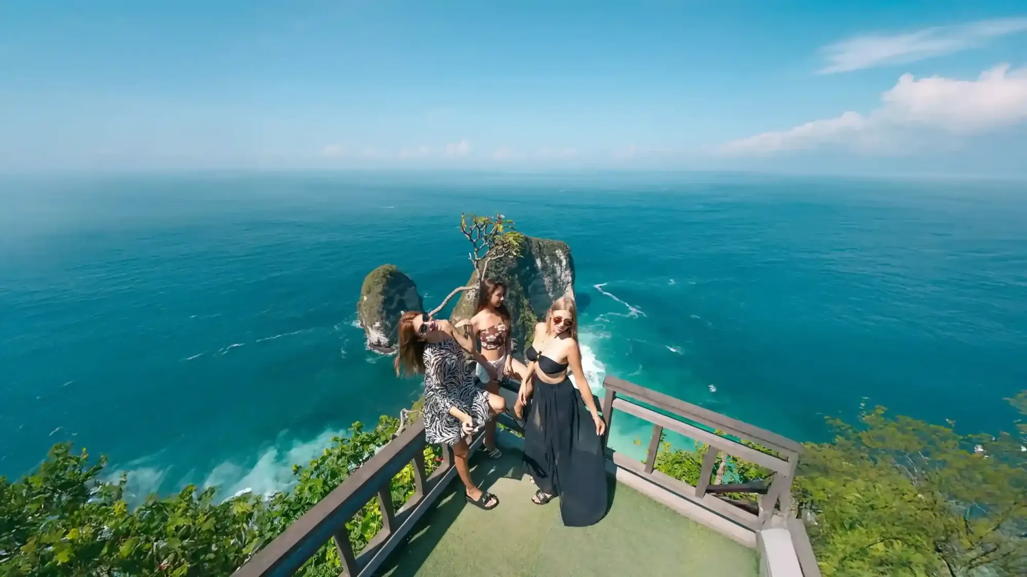 Three women at the Kelingking viewpoint above the sea, Nusa Penida