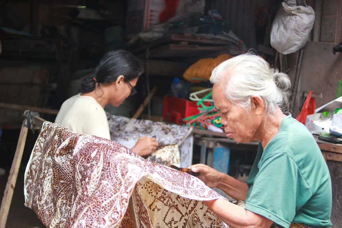 Mother and daughter drawing batik tulis by hand, Indonesia